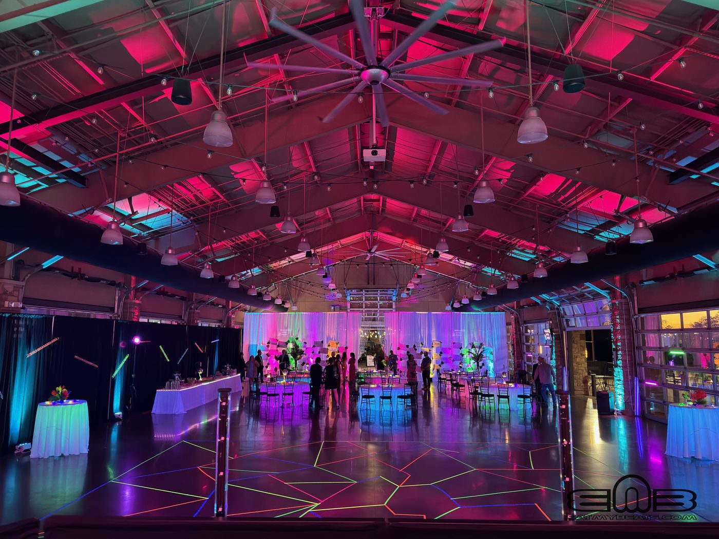 University of Alabama community event with stage and balloon arch