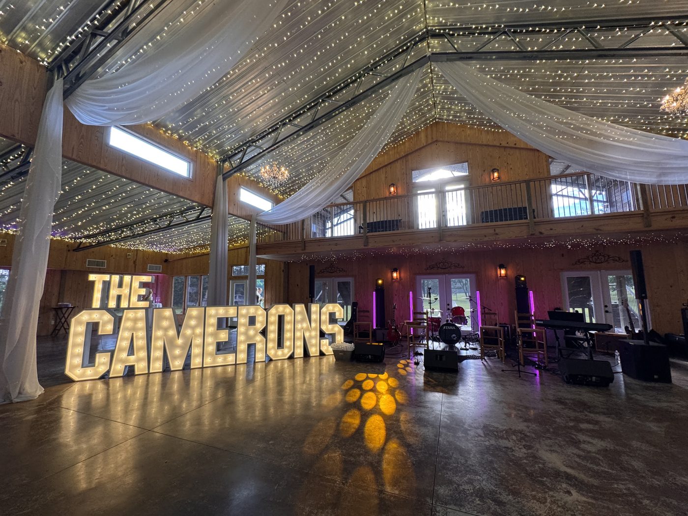 Prom stage decor with fireworks graphic and balloon arch