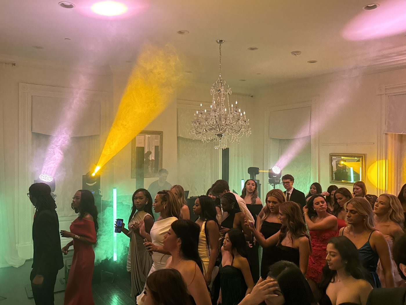 DJ booth with rainbow uplighting in an elegant venue
